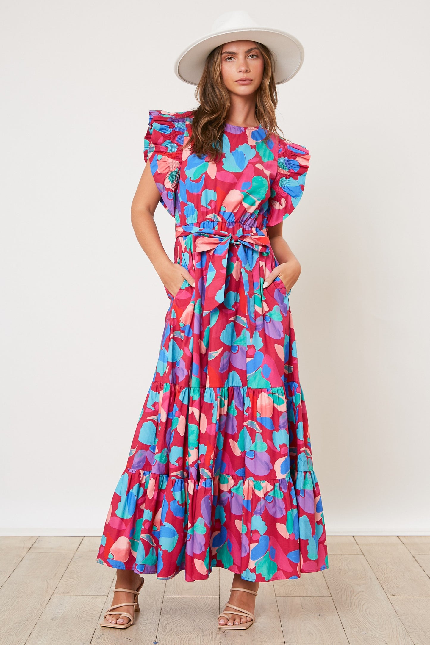 The Kimberly Dress features a floral waist tie and a tiered poplin design, creating a flattering silhouette. Its sleeveless cut is complimented by a shoulder ruffle and a mock neck, giving it a chic and stylish look. The dress showcases a beautiful floral print pattern and is complete with a waist tie for a polished finish.
Fabric: 100% Cotton