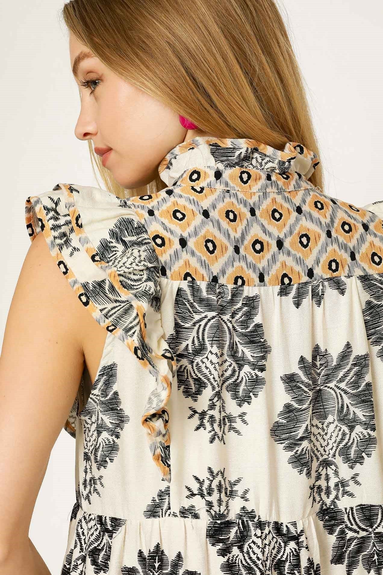 Woman wearing a sleeveless top with a geometric pattern on a white background