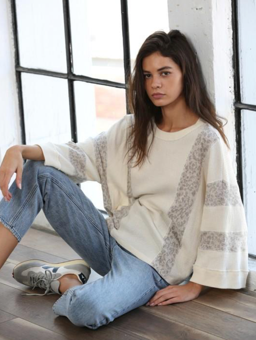 Crafted from a cozy knit material, this top features 3/4 length sleeves and a round neckline for a relaxed and oversized fit that is perfect for everyday wear.