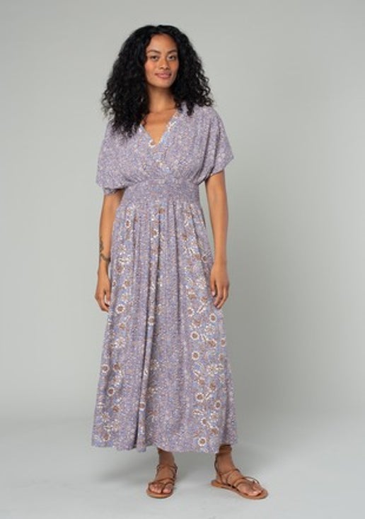 Chelsea Dress - Mindy's Boutique - This elegant dress showcases a beautiful floral pattern and boasts a surplice v neckline and short kimono sleeves. The smocked waistline adds a touch of sophistication, while the open back with fabric tie and side slit add a flirty and alluring element to the design.