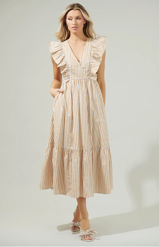 The Madge Striped Fairness Poplin Surplice Midi Dress has us planning our next summer vacation! Featuring a deep V neckline framed by ruffle details that act as an extended shoulder and trail down to the waistline. An effortless midi skirt maintains an A line silhouette with a single ruffle tier. Breathable cotton works to shape a flowy midi dress. Bring it on your next trip and style it with heels or sandals!

- Surplice

- Button snap

- Breathable

- Poplin

- Color: Taupe Multi

Size + Fit

- Model is 5