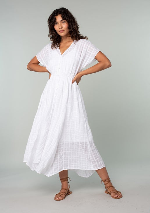 Subtle textured gingham midi dress with a v neckline, dolman sleeves, and handkerchief hem. Features a functional button front, elastic waistline, and detachable lining. Pair with a beautiful crochet tote for the perfect vacation look.

Details:

Fabric: 100% Cotton

Brand: Lovestitch