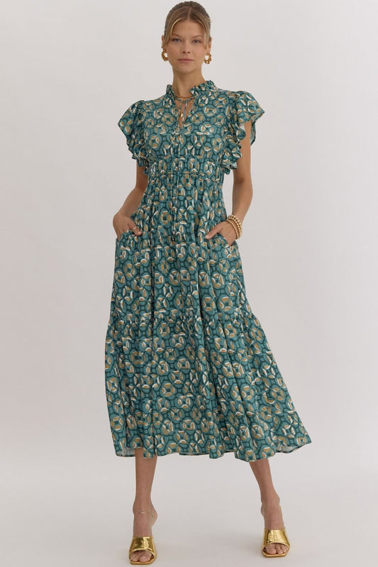 This midi dress features a printed v-neck and ruffle sleeves, with smocking at the waist and a self-tie at the neck. It also includes a pocket at the sides, as well as ruffle detailing. The dress is lined and made of a lightweight woven material that is not sheer.

Fabric Content:&nbsp; 85%RAYON 15%NYLON
Model&nbsp;5'10" and wearing size Small.
Color: Green&nbsp;