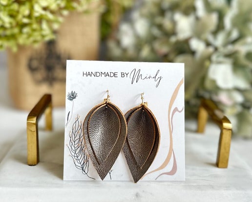 The Shirley Earrings are sure to turn heads. These lightweight pewter colored genuine leather reverse teardrop earrings are so fabulous and easy to wear!! They are for sure going to be your new go-to everyday earrings.

Hypoallergenic, lightweight, nickel, lead, and cadmium free.

Length 2.5”