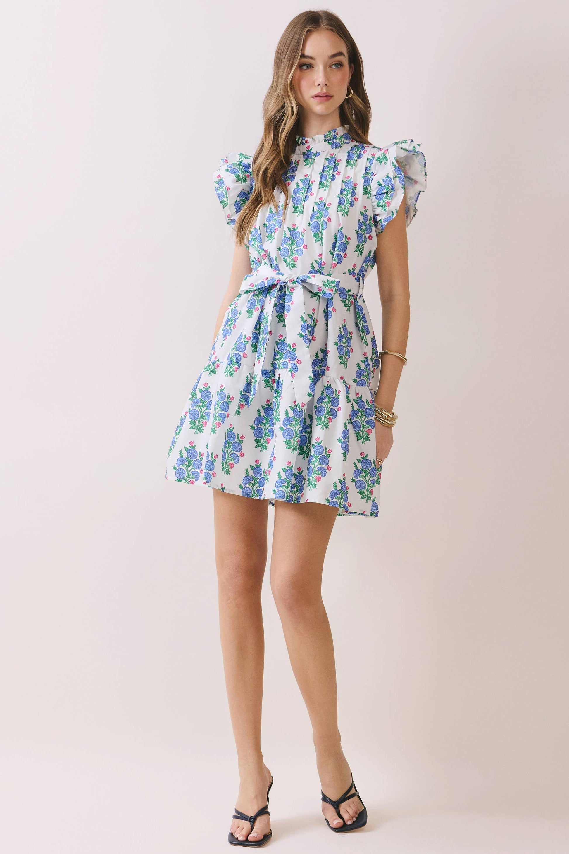 Woman wearing a floral dress on a plain background