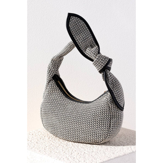 Turn heads with the Sonya Mini Hobo. Made with an elegant woven design featuring PU accents and a delicate knot detail, this bag has every trend you could hope for all in one. Polypropylene, raffia and smooth PU, single handle, top zip closure, 1 inner zip pocket, 1 inner slip pocket.

Details

• Dimensions: 10.5 x 3.3 x 5.8 in (26.7 x 8.3 x 14.6 cm)

