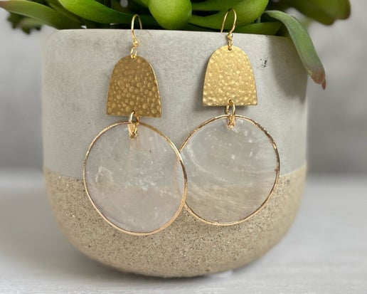 The Susie Earrings feature a unique combination of semi-translucent Capiz Shell and Brass. These eye-catching earrings add a playful touch of elegance to any outfit.

Hypoallergenic, lightweight, nickel, lead, and cadmium free.

Length 2.11”