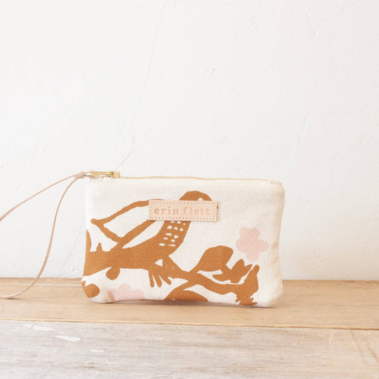 Pouch with bird design on a wooden surface